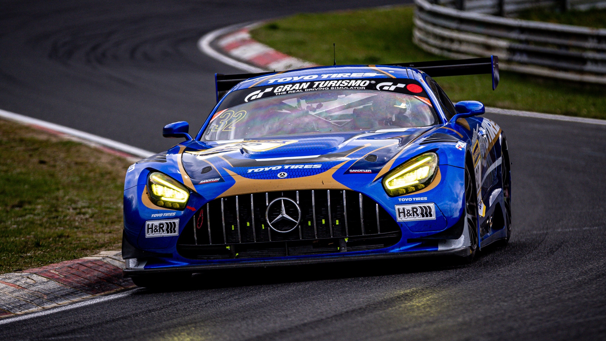 blue Toyo Tires race car Mercedes AMG on the Nürburgring race track during a long distance race